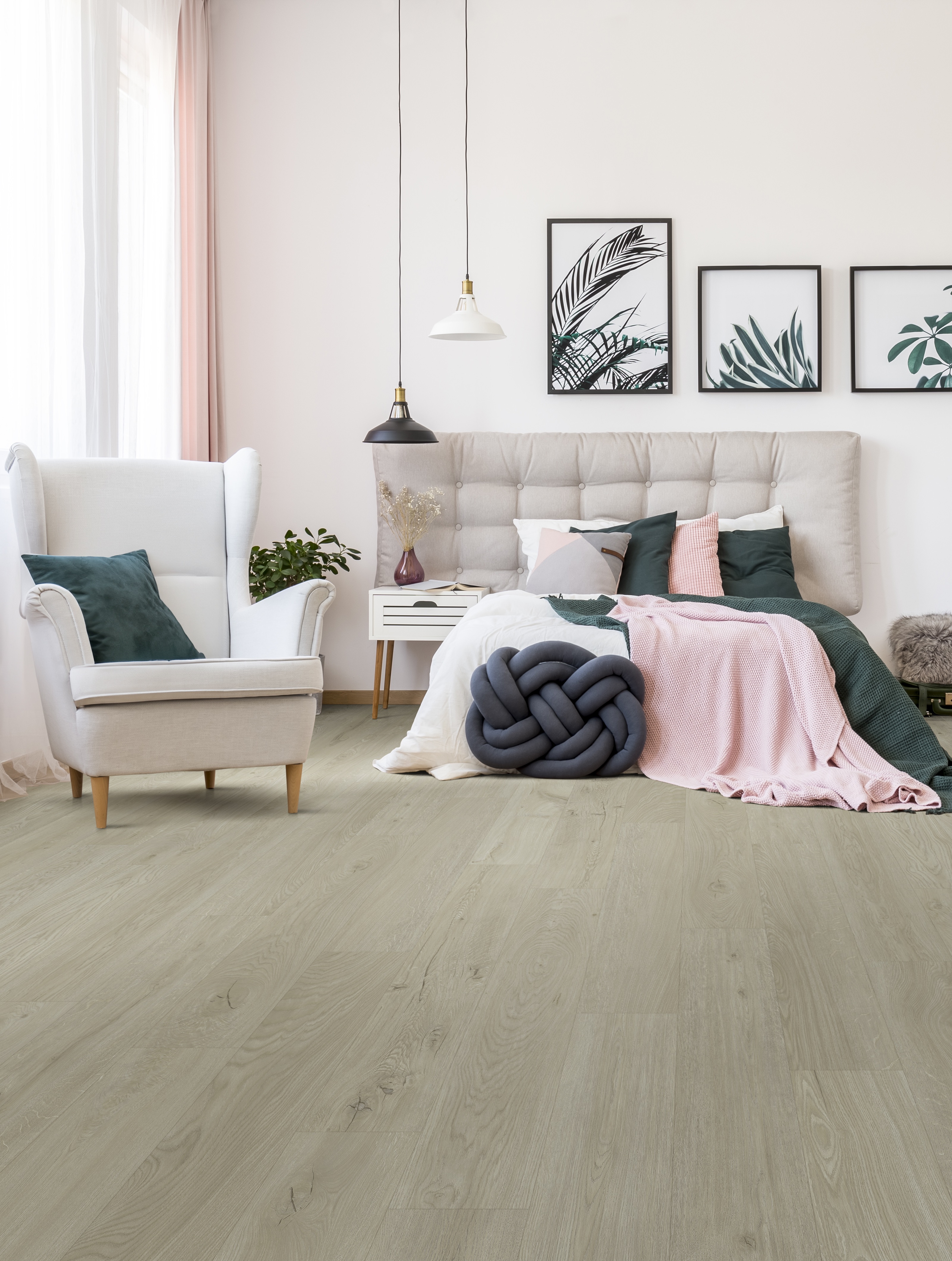 Black and white carpet with asymmetric patterns in front of double bed, armchair and white shelf in bedroom interior